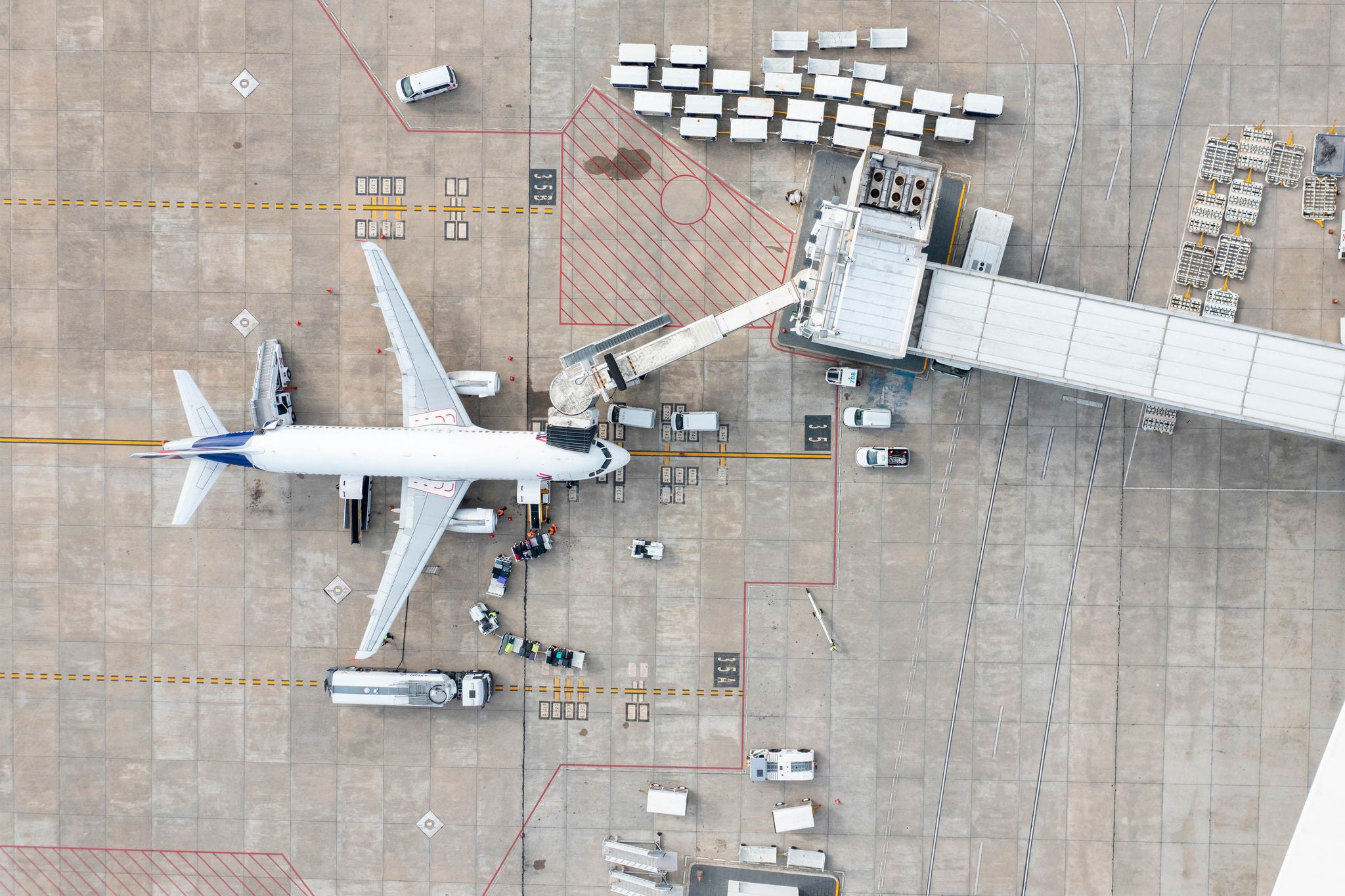 Aerial view of Aeropuerto de Carrasco with airplanes on the runway and terminal