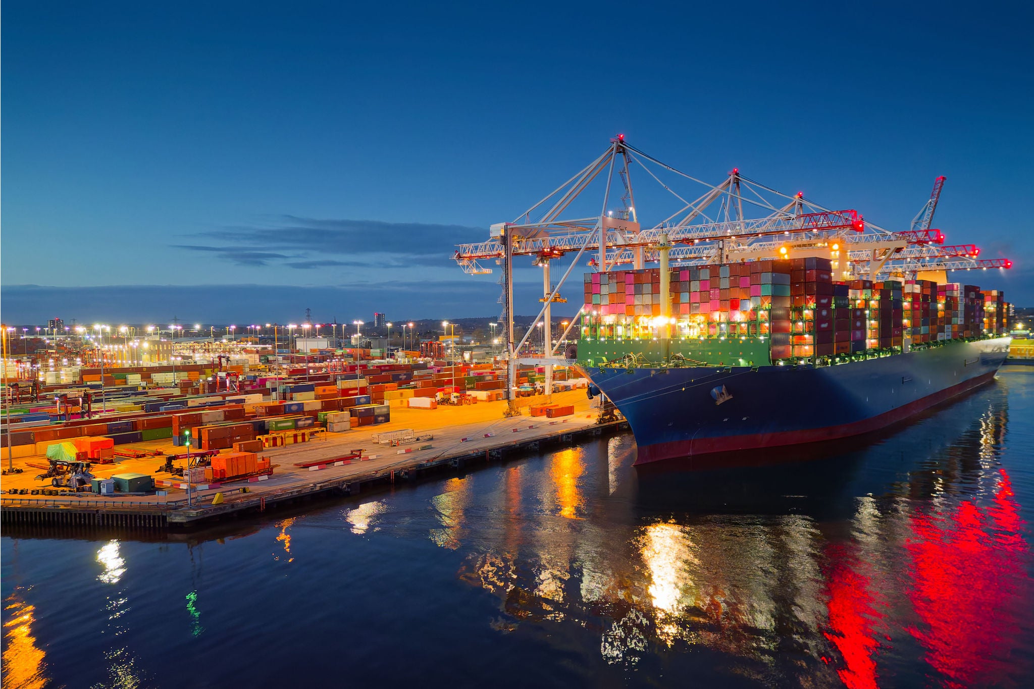Beautiful light reflection on calm sea and dark blue sky. Place of work in shipping industry.