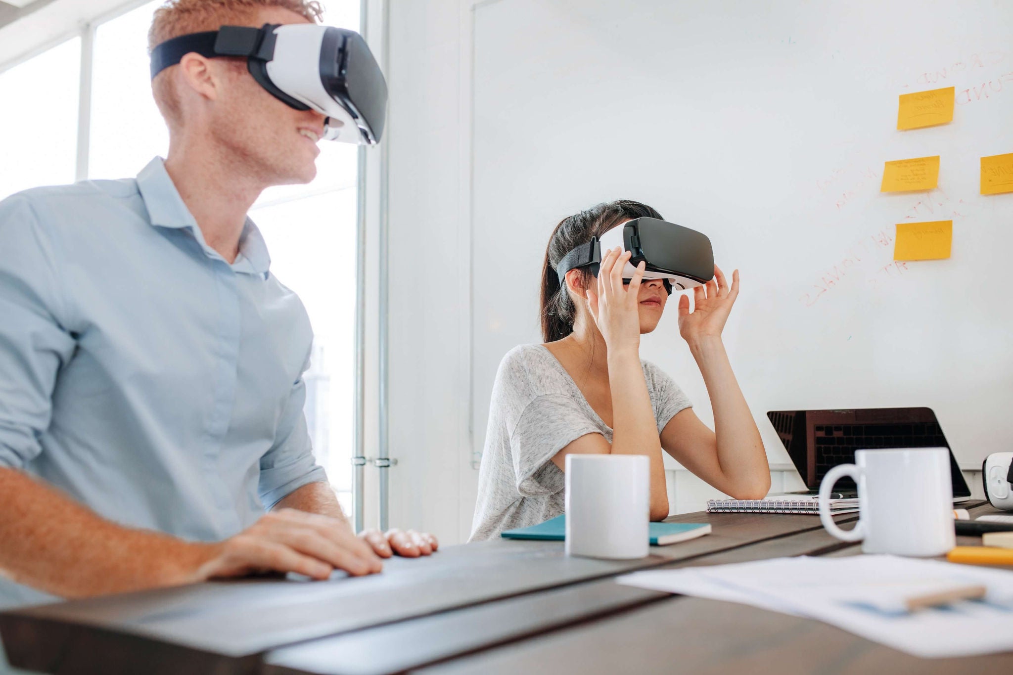 A man and woman wearing VR headsets