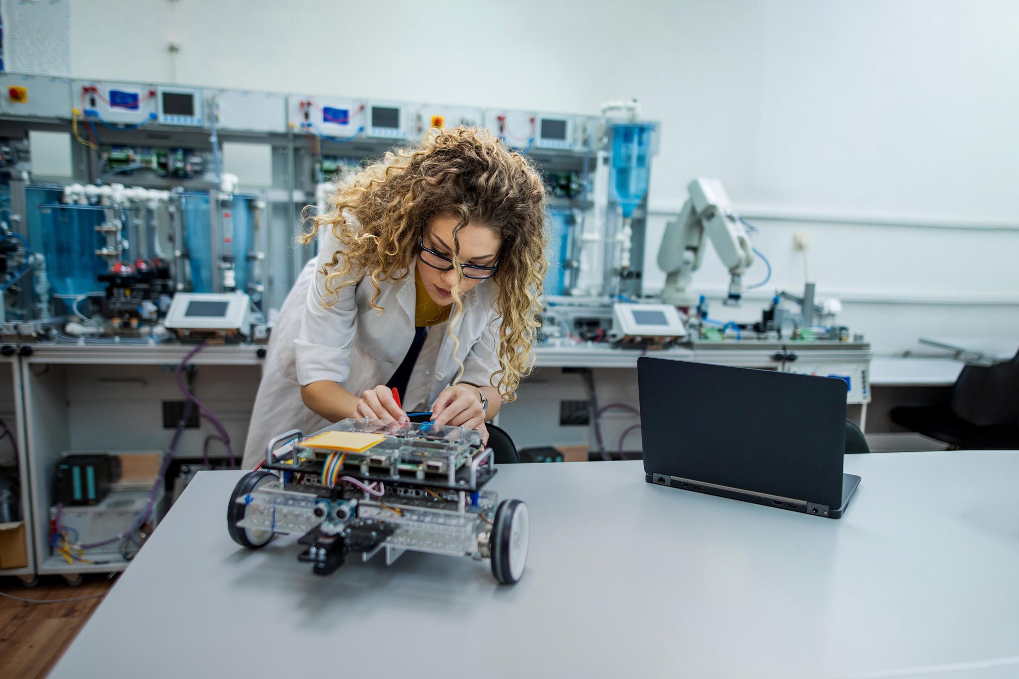 Young engineer analyzing new robot project