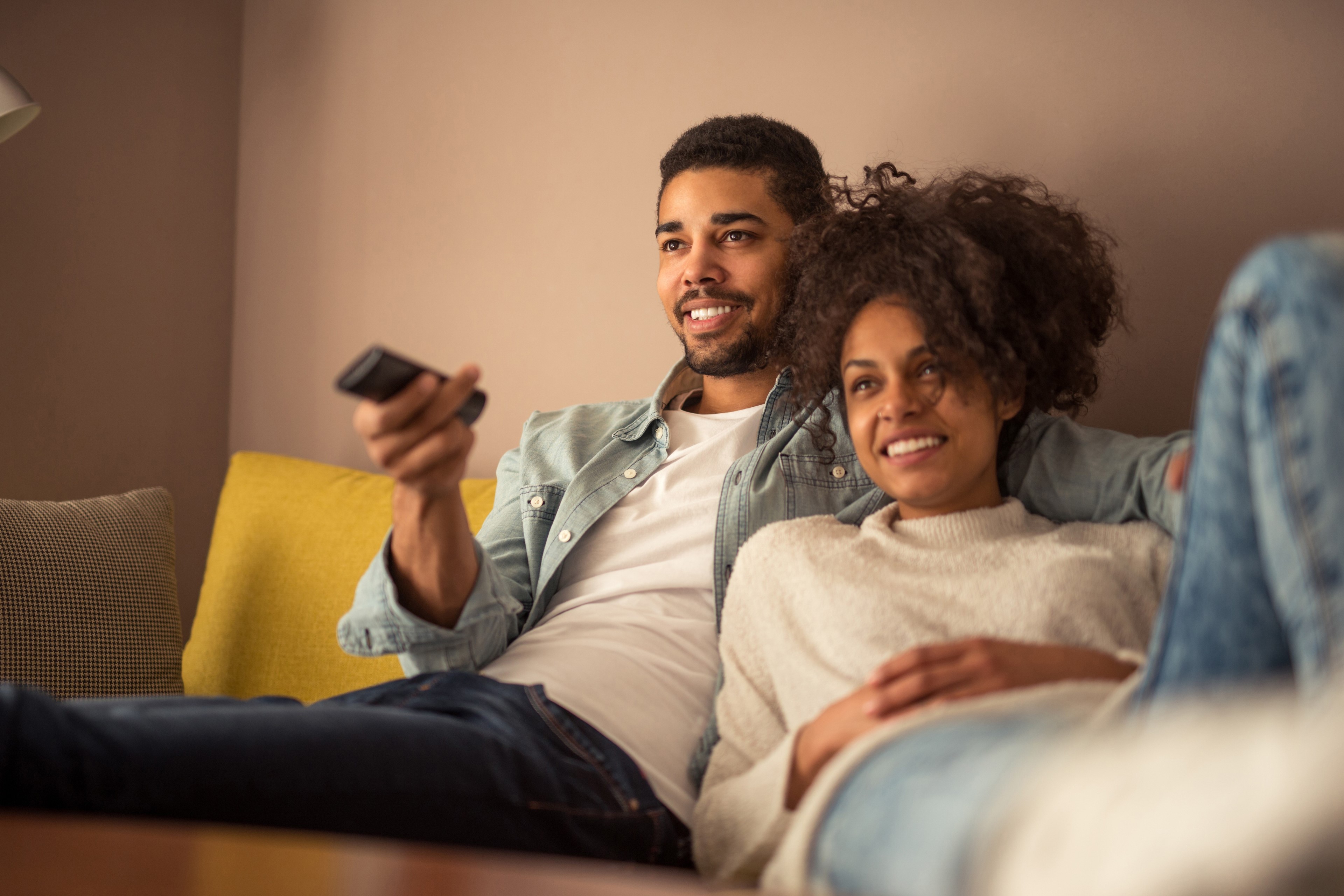 EY couple watching television